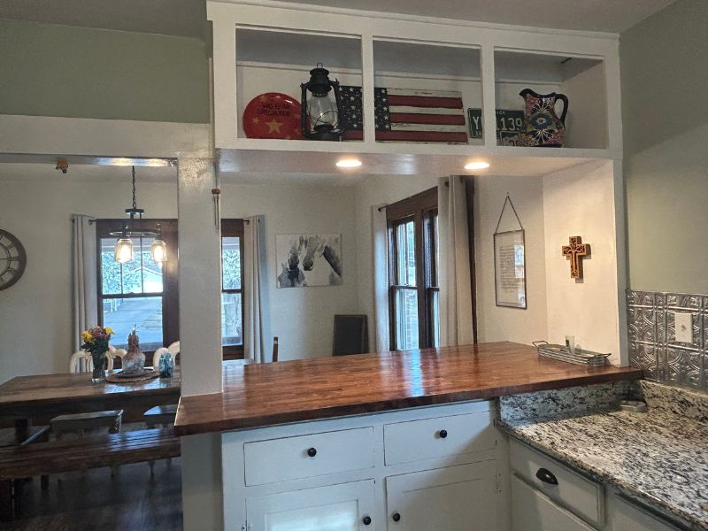 Built-in island and kitchen cabinets with custom stained butcher block countertop.