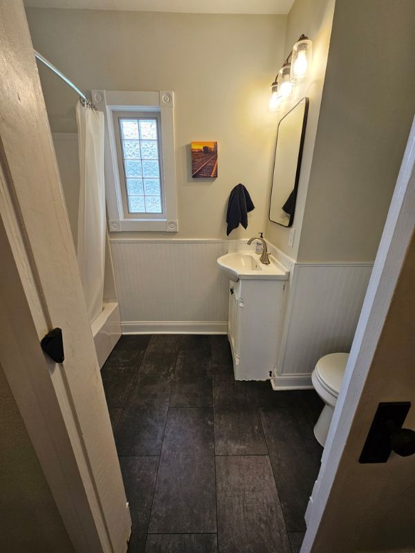 Charcoal grey tile updates the space in a main floor bathroom.