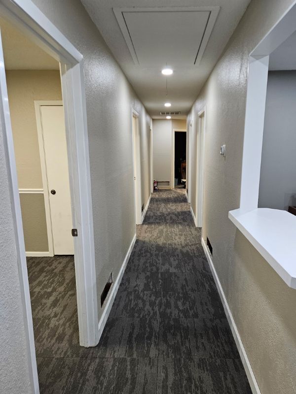 Remodel of a commercial insurance office featuring new carpet tiles and fresh paint.