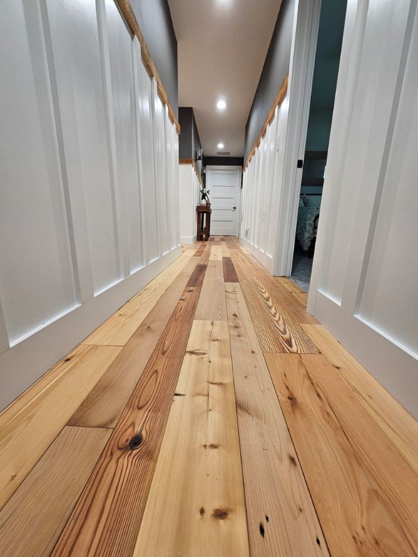 Rustic barn wood flooring in a home addition by Seymour Construction.