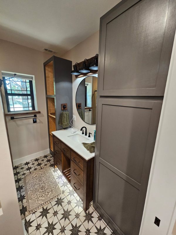 Large bathroom addition in a Hays, Kansas shed house featuring dark cabinets and patterned flooring